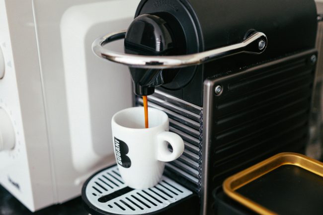 Top Features of DeLonghi Coffee Machines Available at Harvey Norman Brewing Coffee into a White Mug